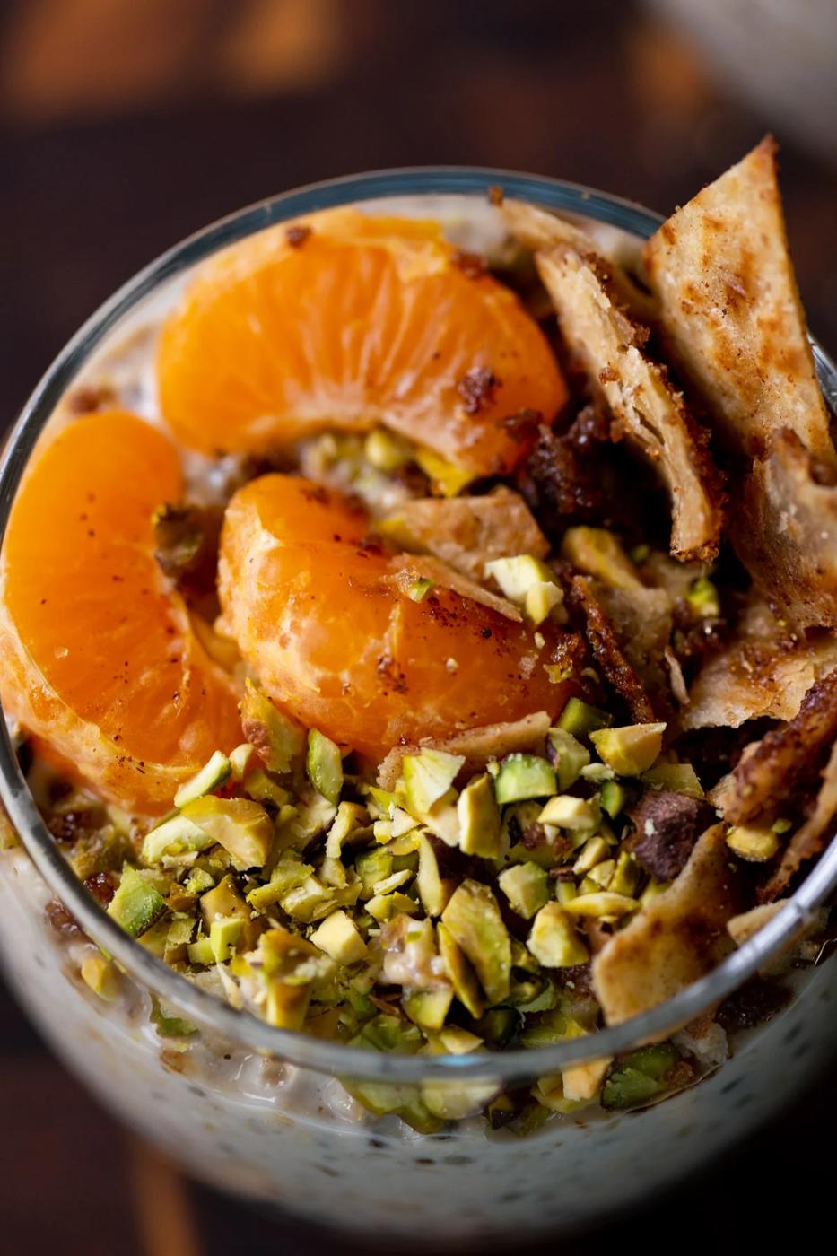 close-up of cannoli overnight oats topping: oranges, pistachios, and crispy cinnamon sugar tortilla pieces