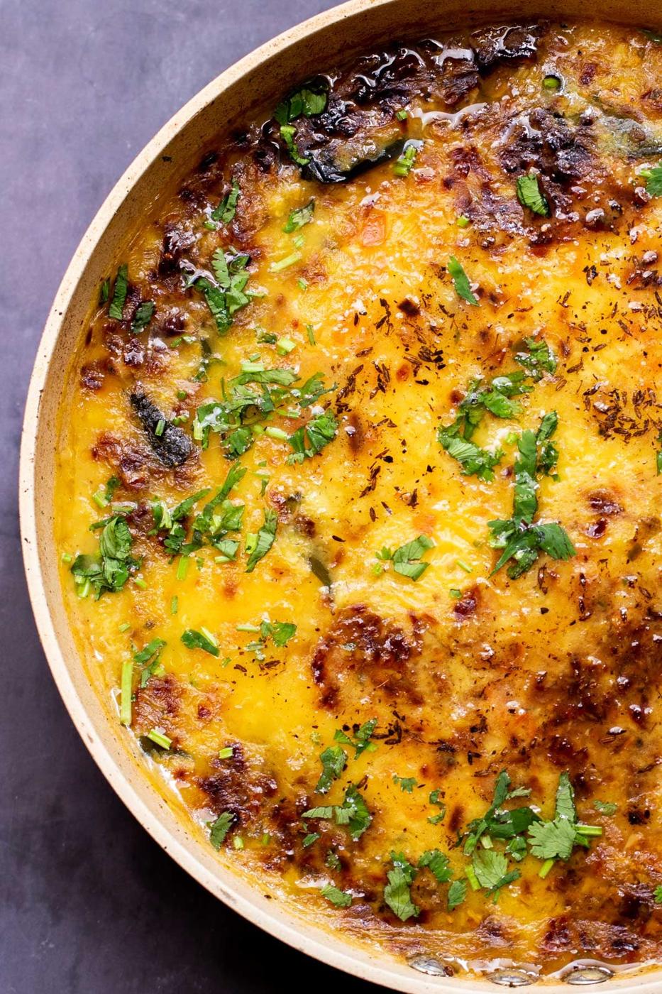 a sauteeing pan with dal topped with chopped cilantro