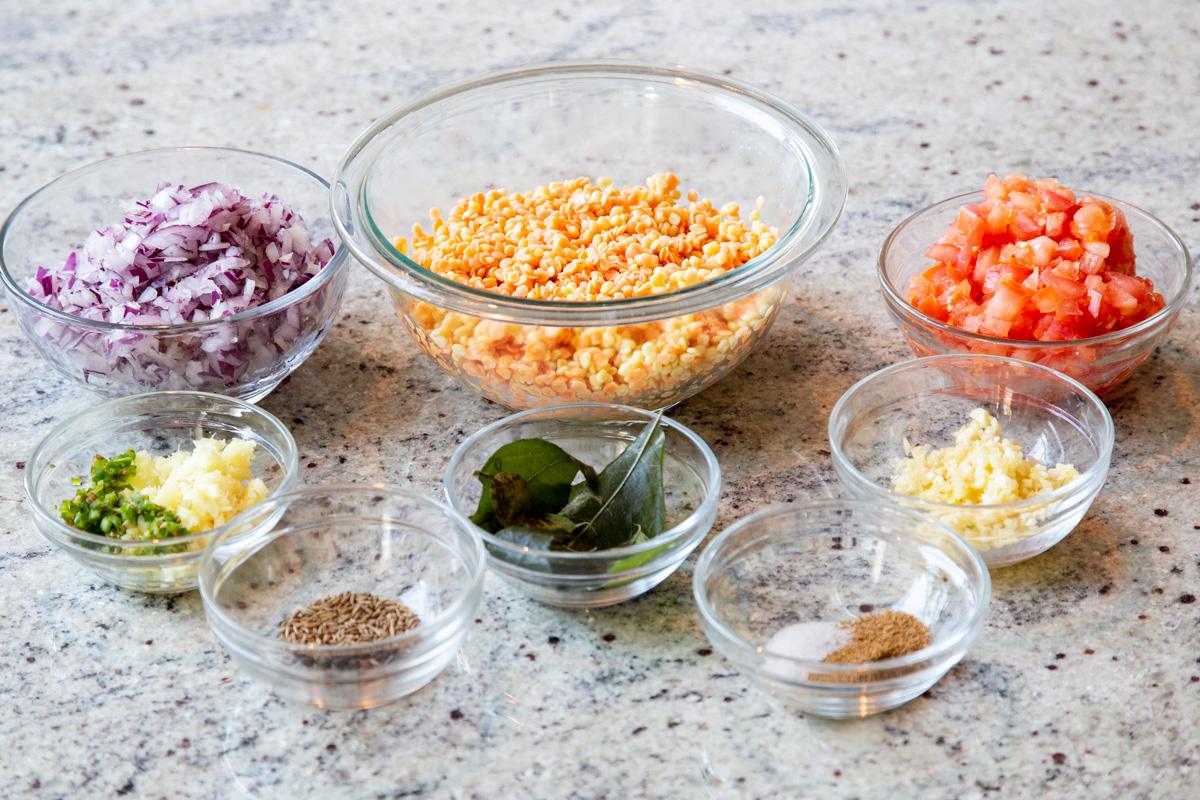 ingredients for making caramelized onion dal on a marble countertop