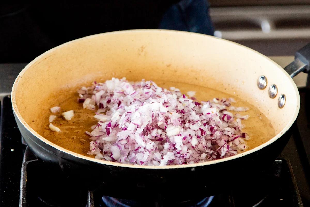 minced onion sauteeing in a bit of oil in a sauteeing pan
