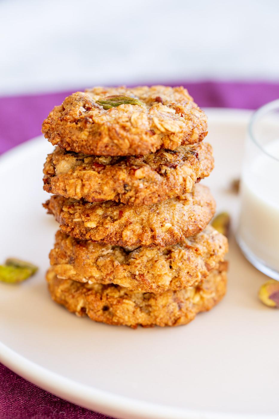 a stack of vegan carrot cake cookies on a small plate