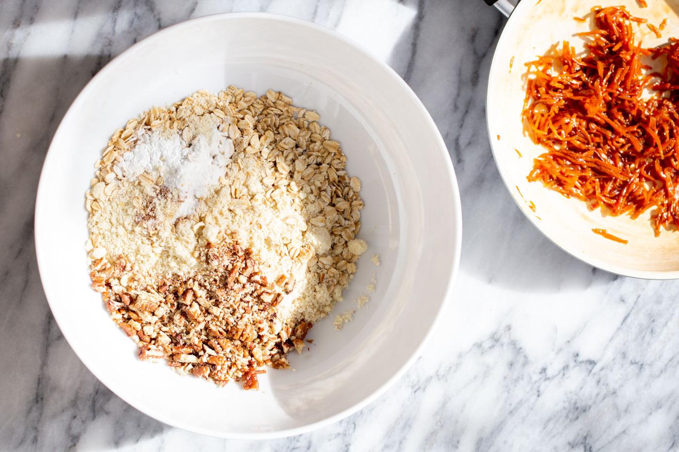 dry ingredients for carrot cake cookies in a white bowl