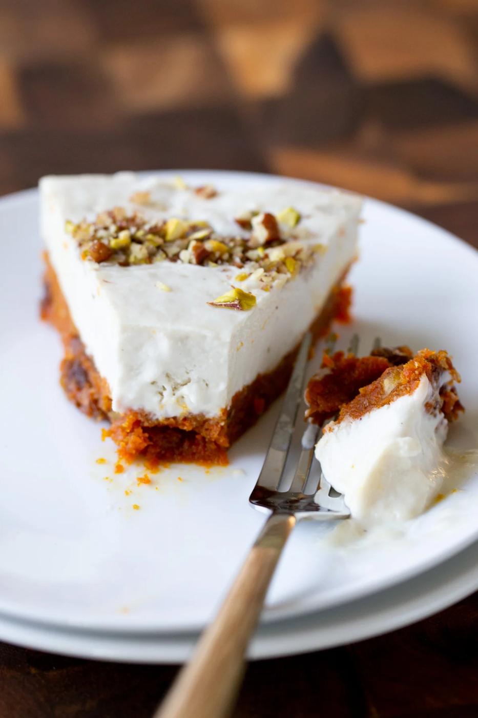 slice of carrot halwa cheesecake with a bite taken out