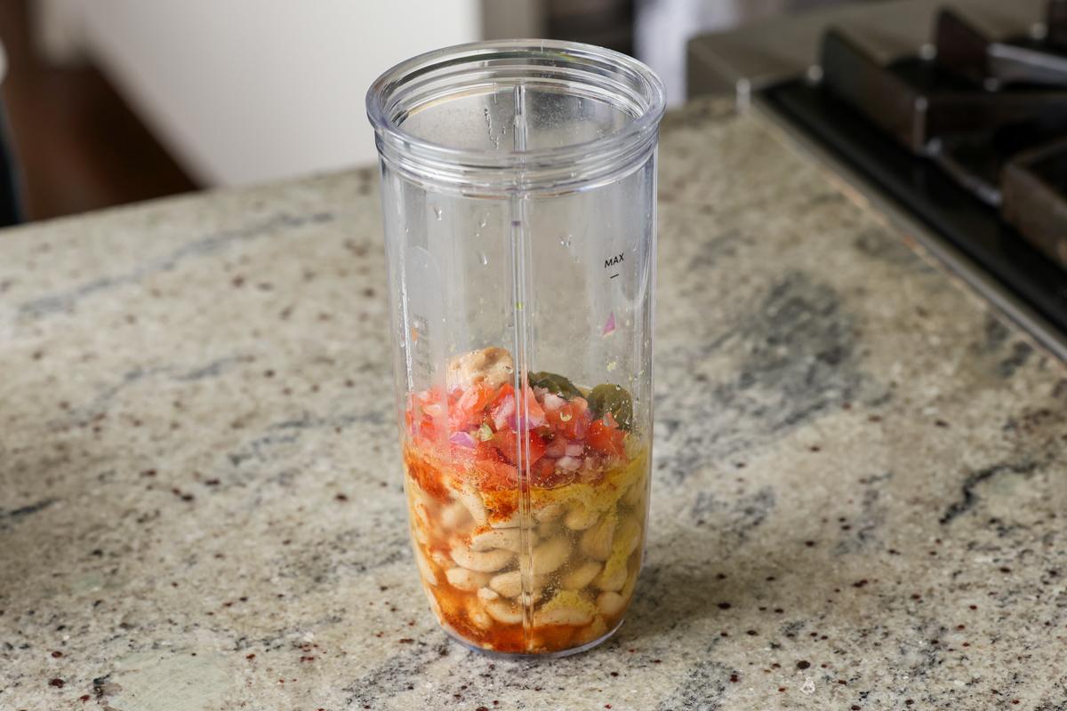 cashews and seasonings in the blender before blending