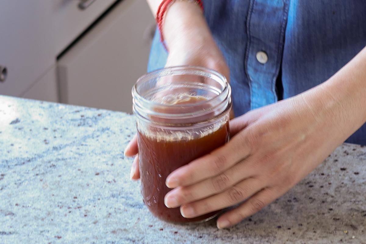 picking up the jar of chai concentrate