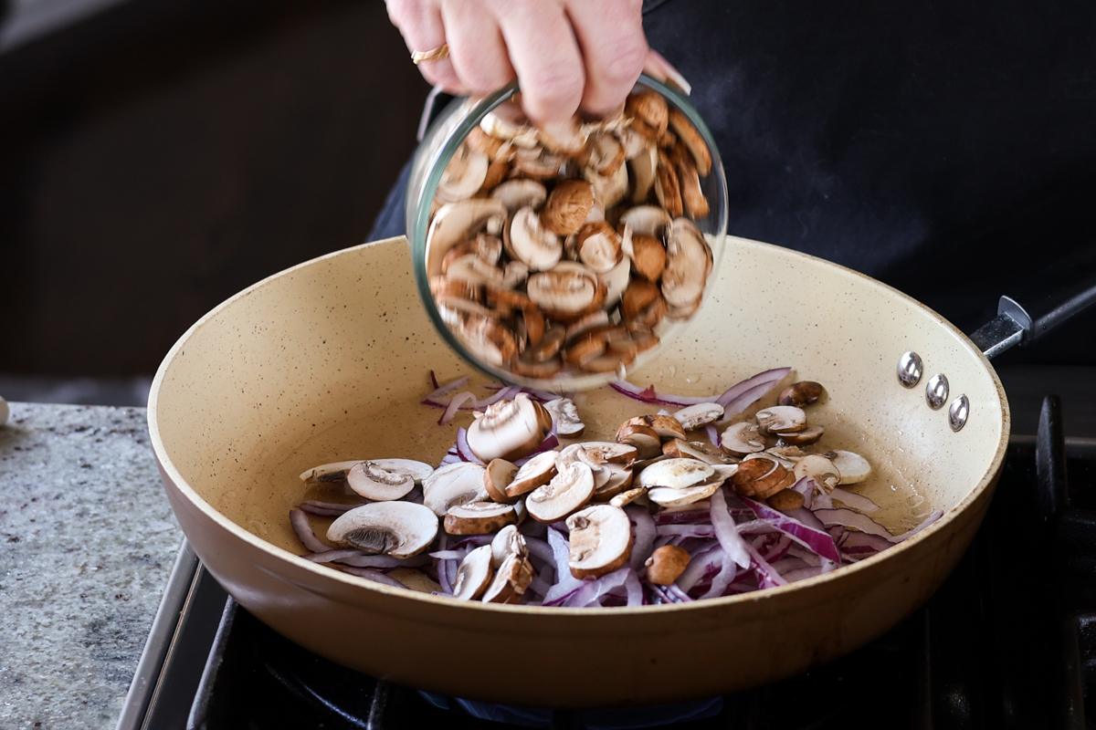 adding mushrooms to the pan