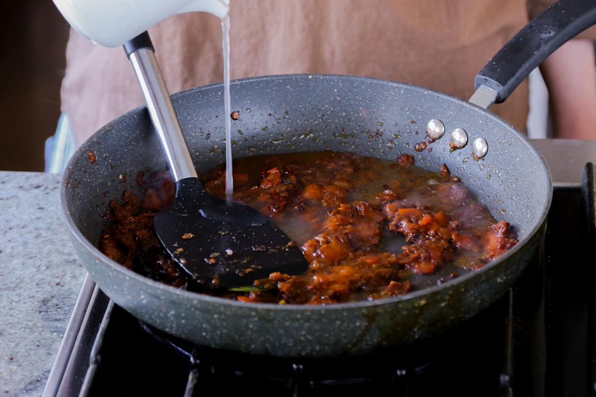 adding water to the pan