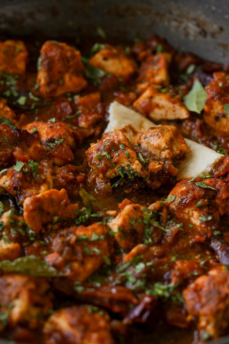 Chettinad pepper chicken curry in the pan with flatbread