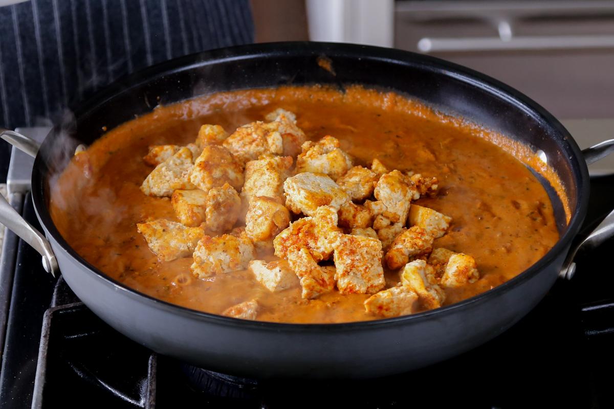 adding tofu to the angara curry sauce