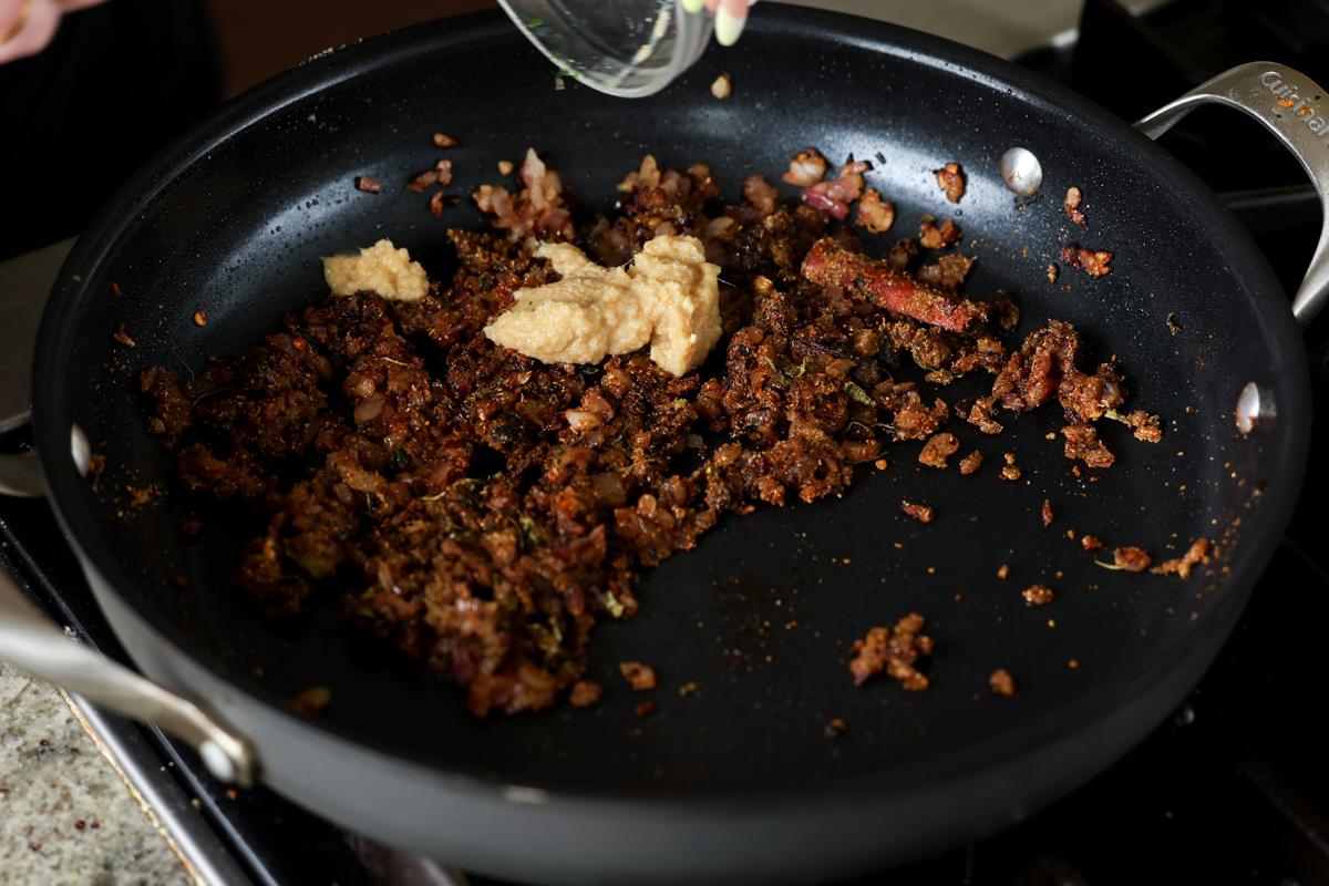 adding ginger garlic paste to the pan