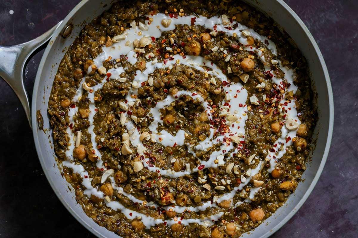 chickpea lentil spinach stew in the pan topped with garnishes