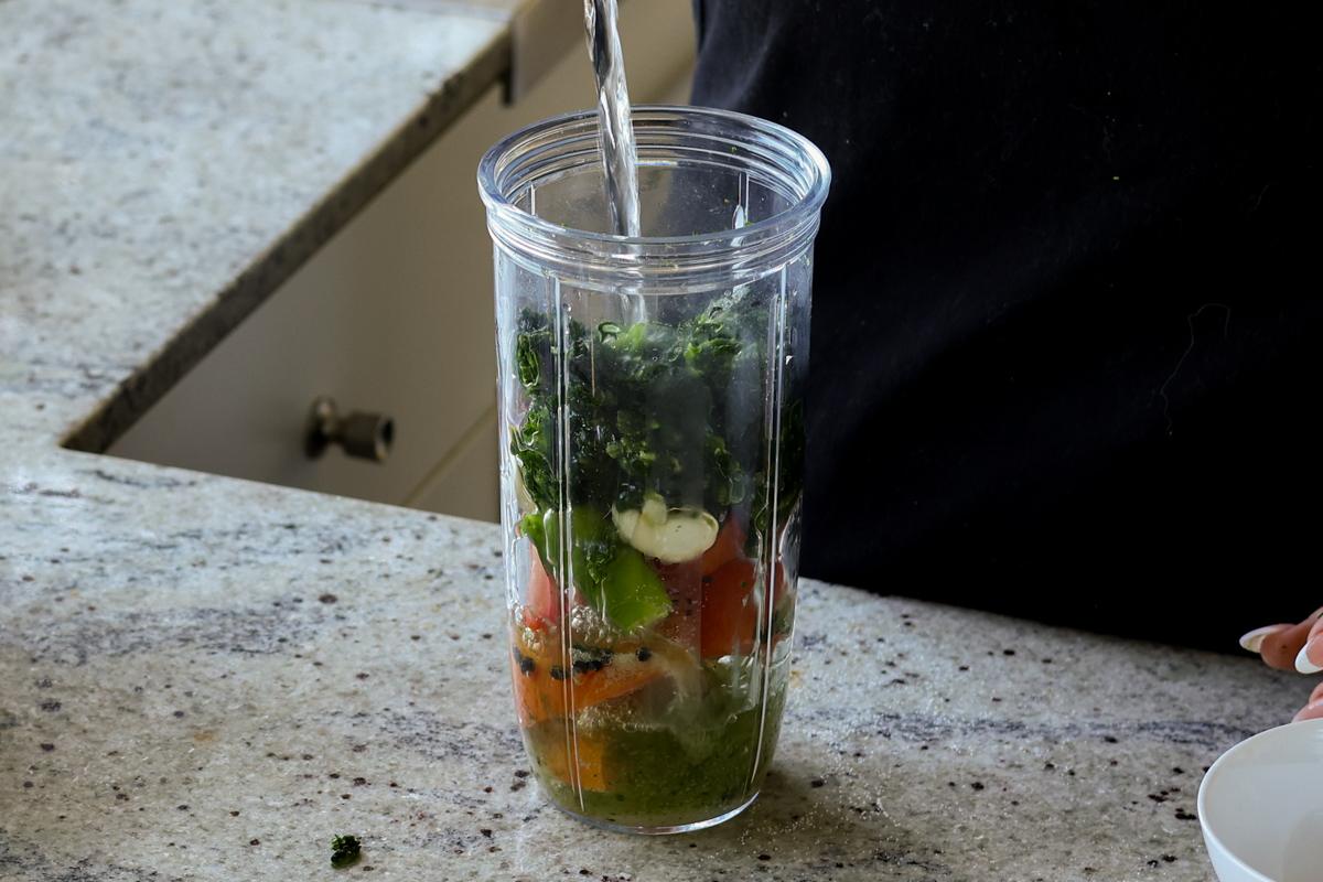 adding spinach mixture to the blender