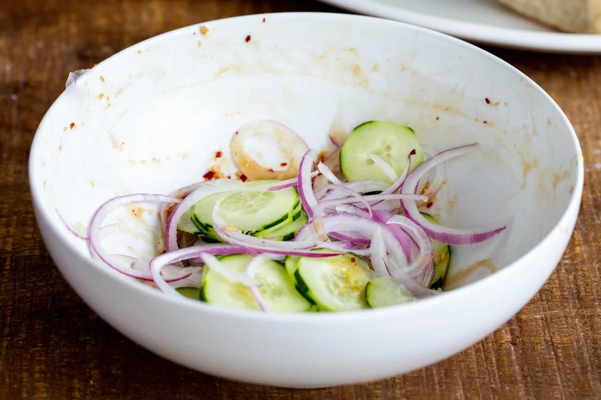 cucumber and onion slices in a small bowl