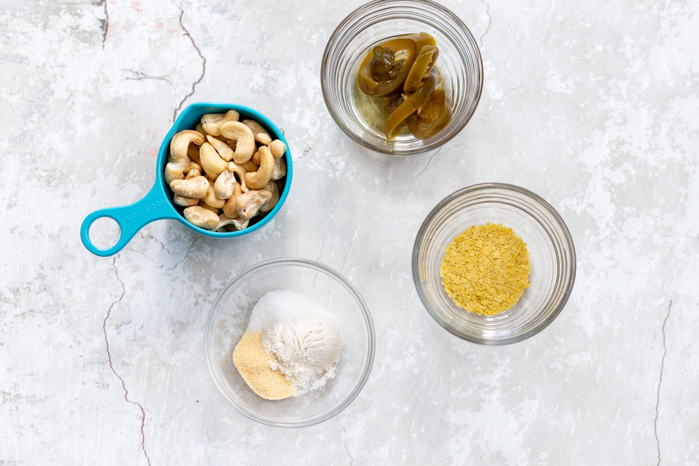 Ingredients for Vegan Jalapeno Cream Sauce in bowls and measuring cups