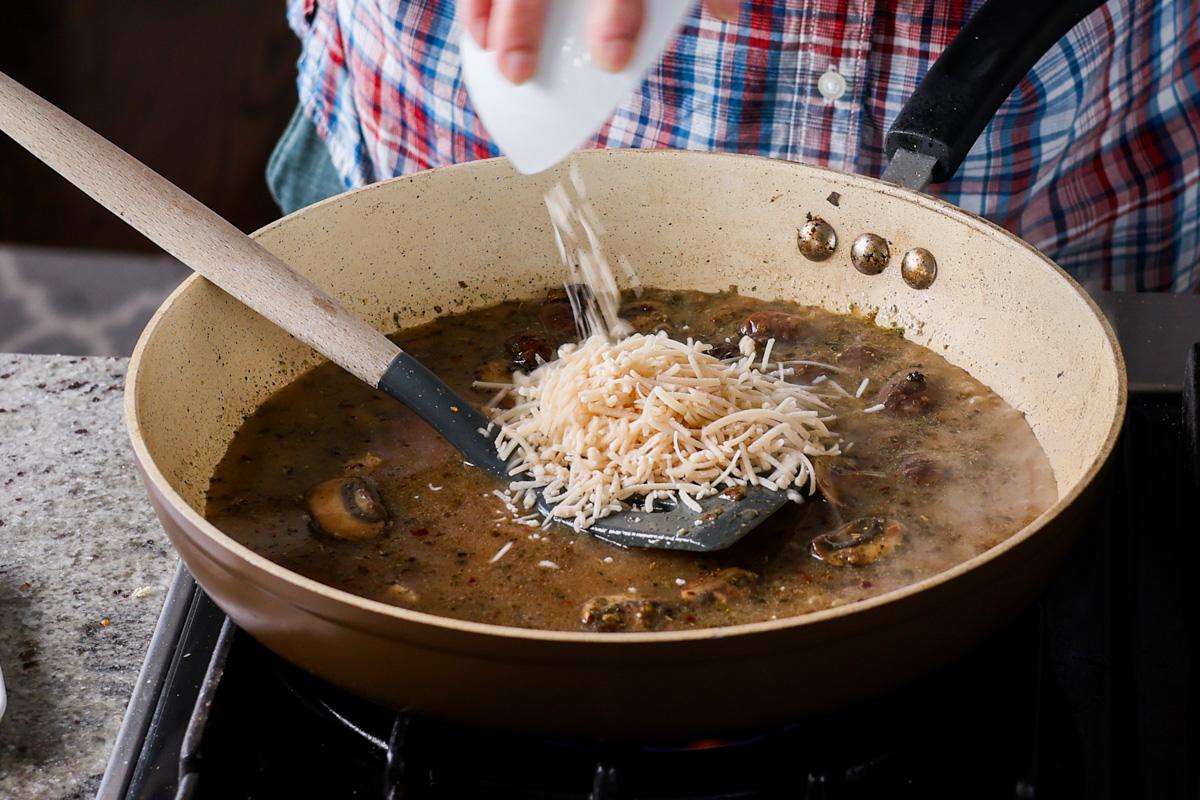 adding vegan cheese to the pan