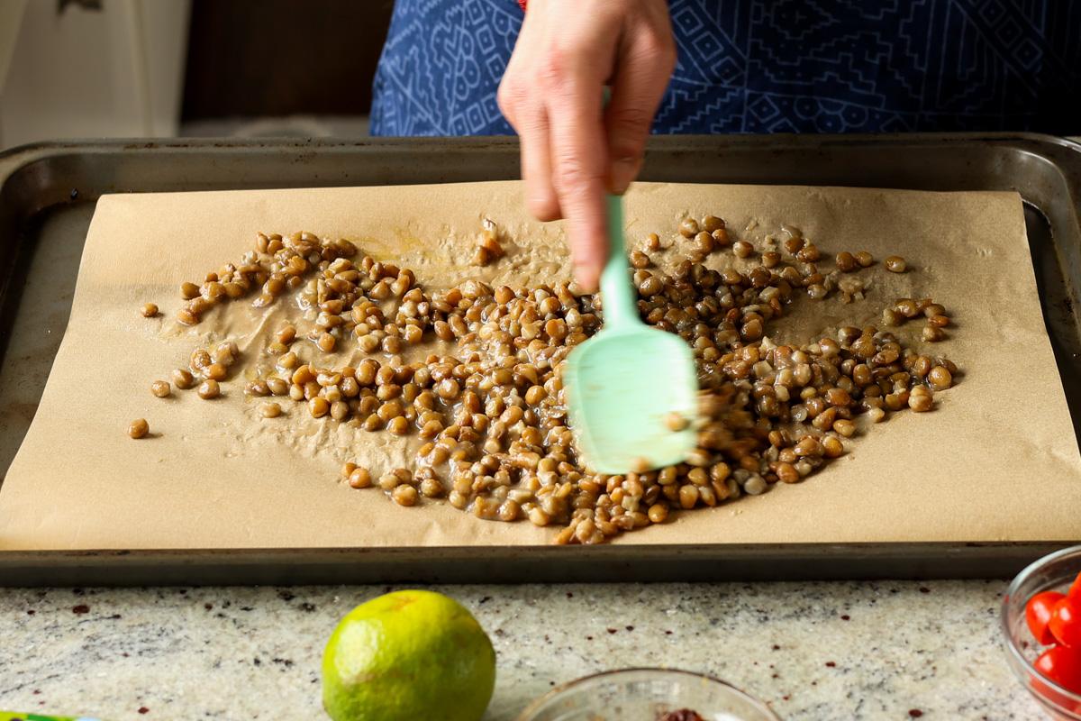 spreading out the lentils on the baking sheet