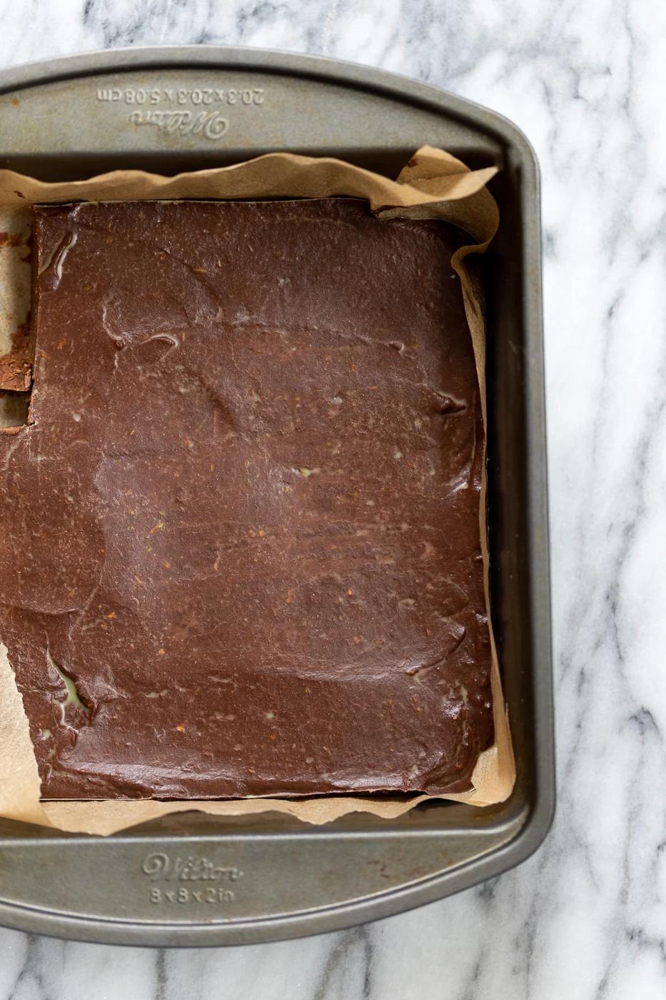Vegan Chocolate Avocado Freezer Fudge in parchment lined brownie pan