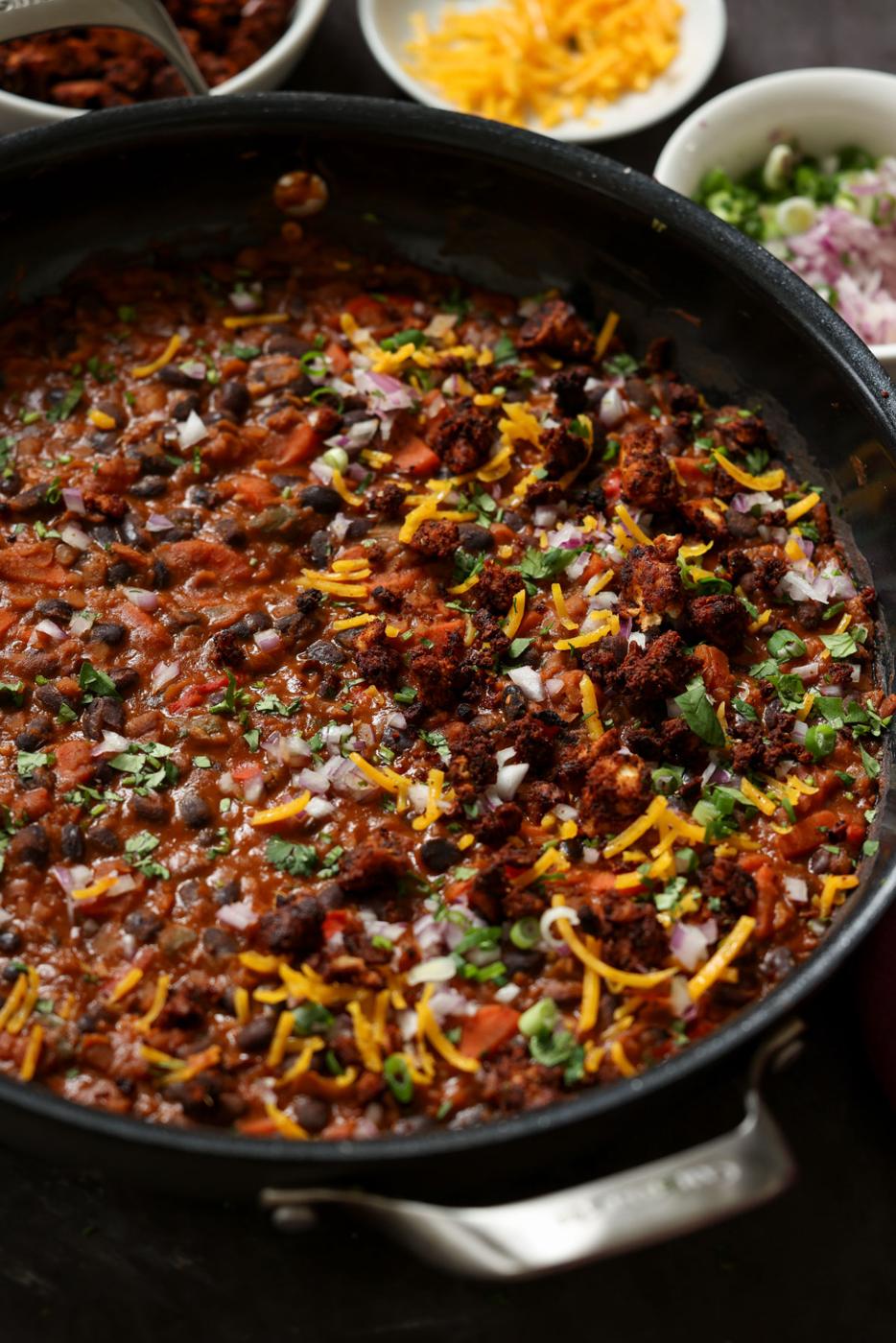 cooked beans in the pan after adding toppings