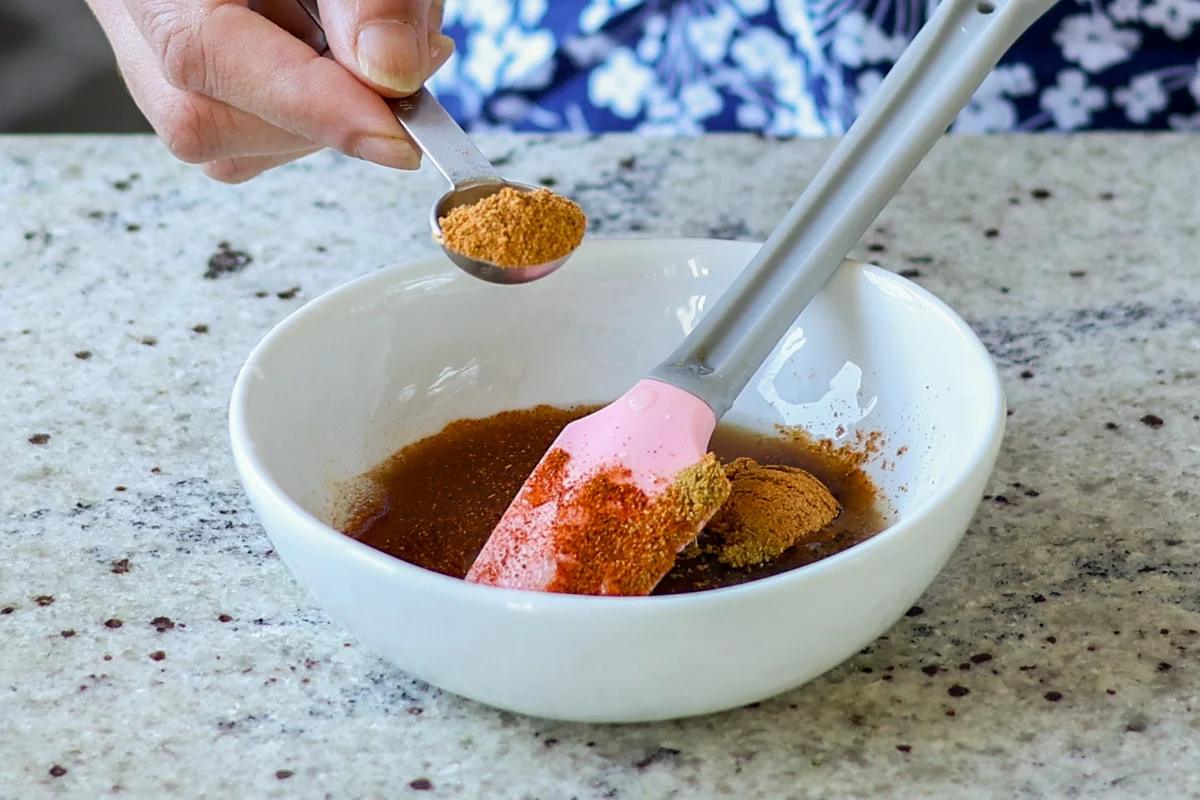 adding sweet chutney ingredients to a bowl