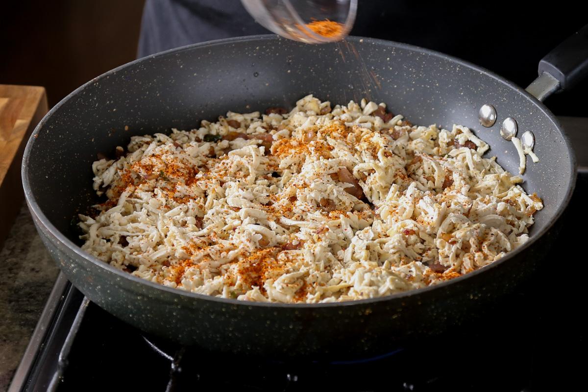 adding spices to the tofu