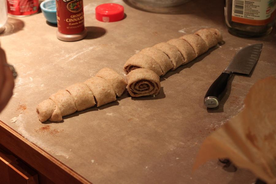 cinnamon rolls being cut