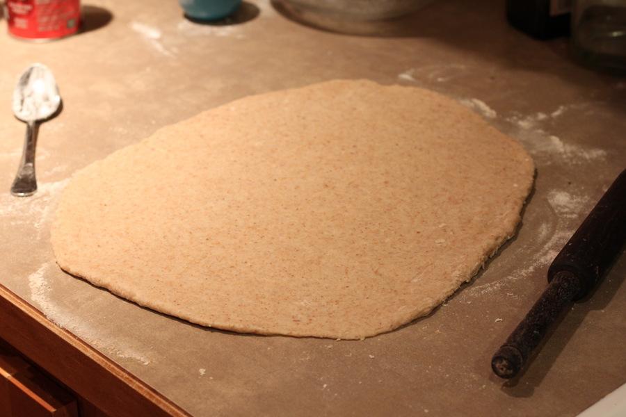 easy vegan cinnamon roll dough rolled into a big rectangle for making buns