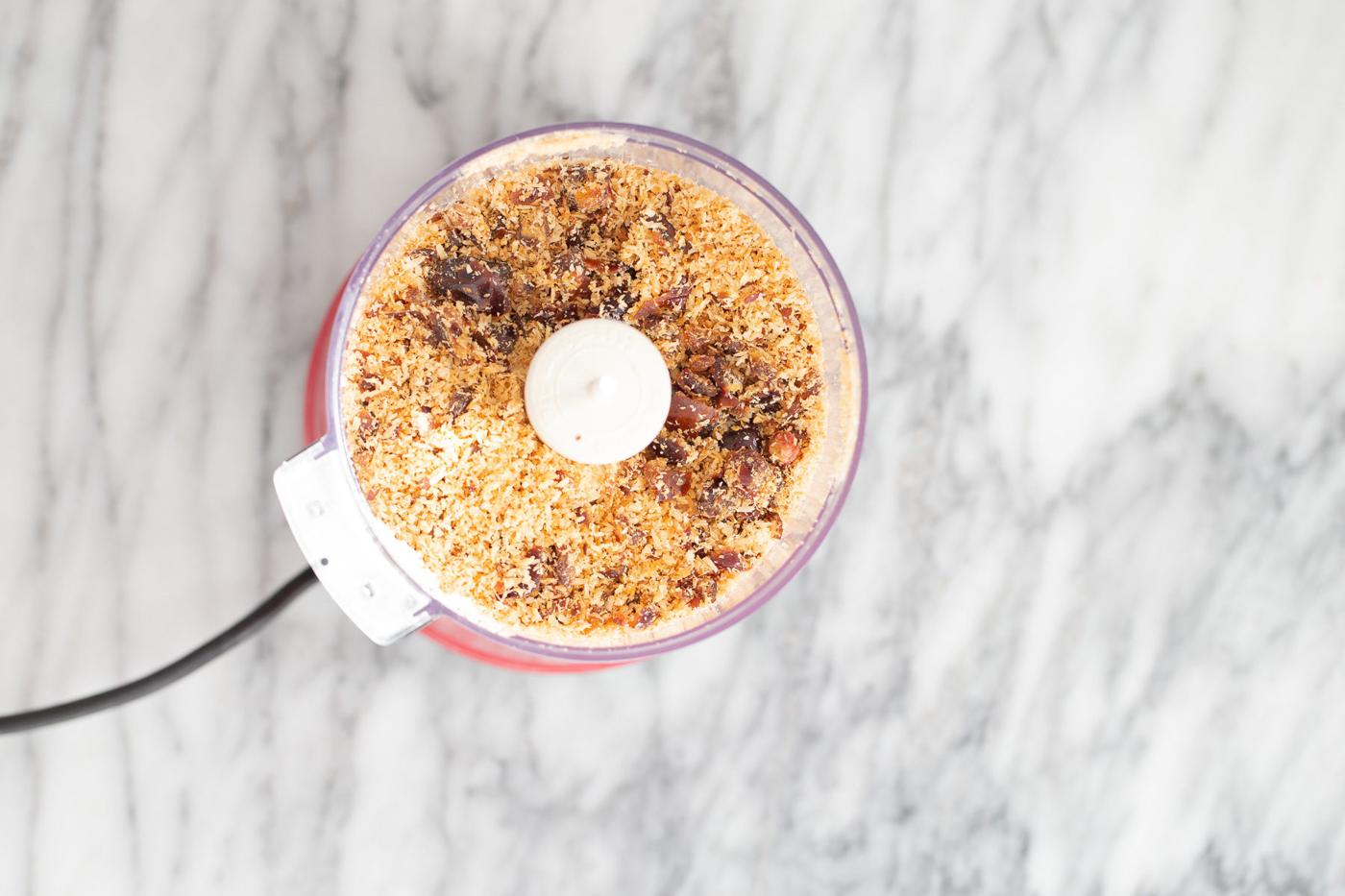 shredded coconut and dates in a food processor