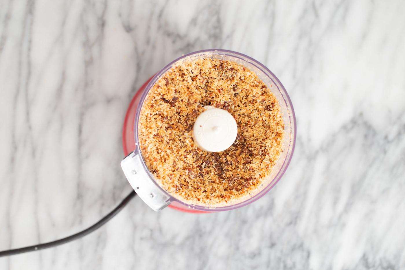 shredded coconut being blended with dates