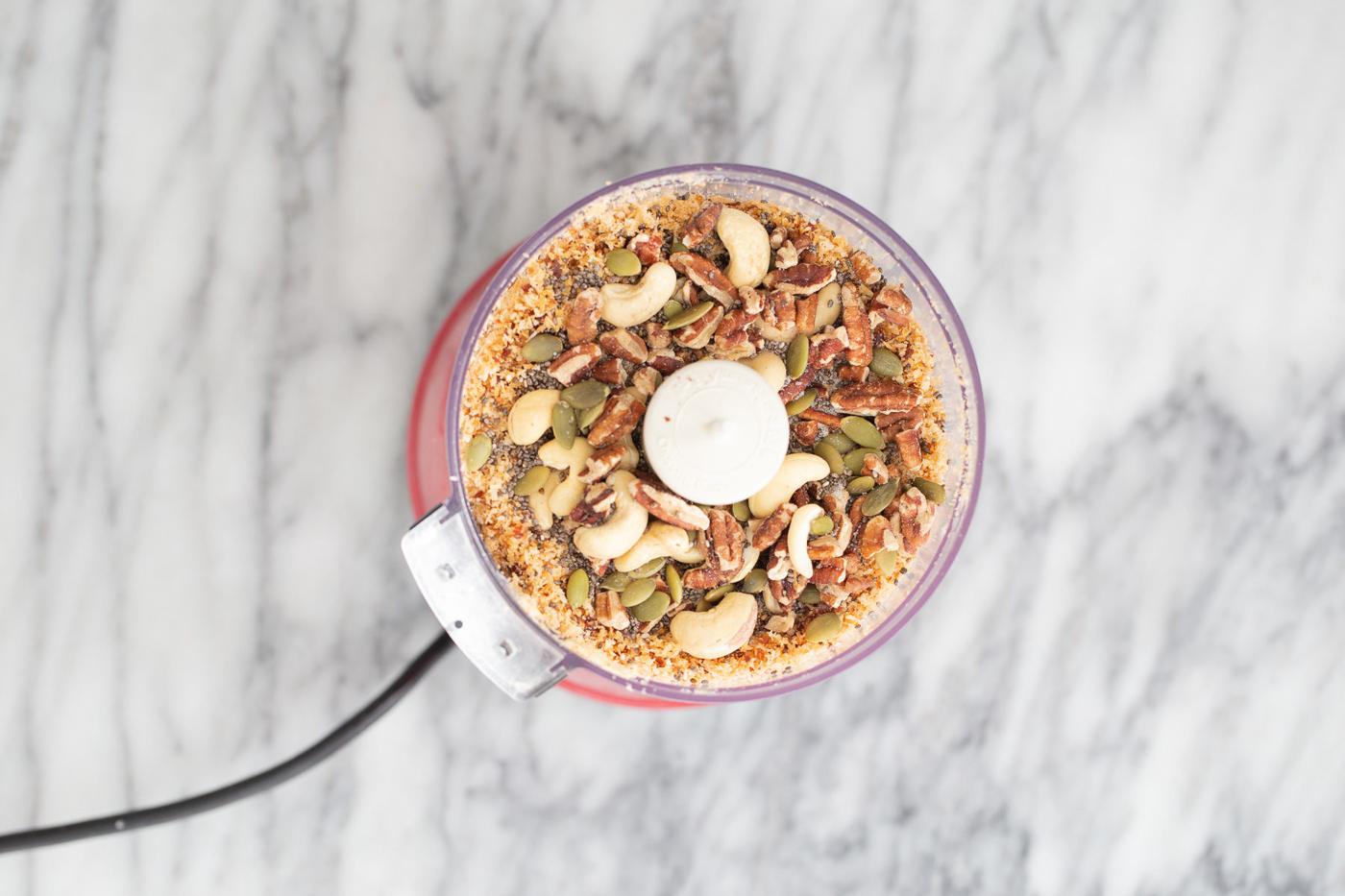 shredded coconuts, nuts, seeds and dates in a food processor