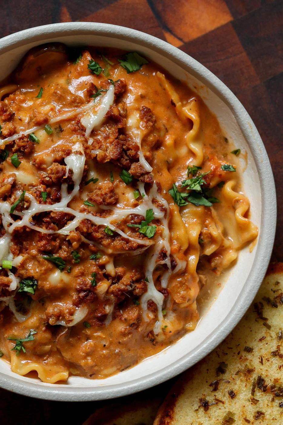 bowl of creamy lasagna soup with garlic bread
