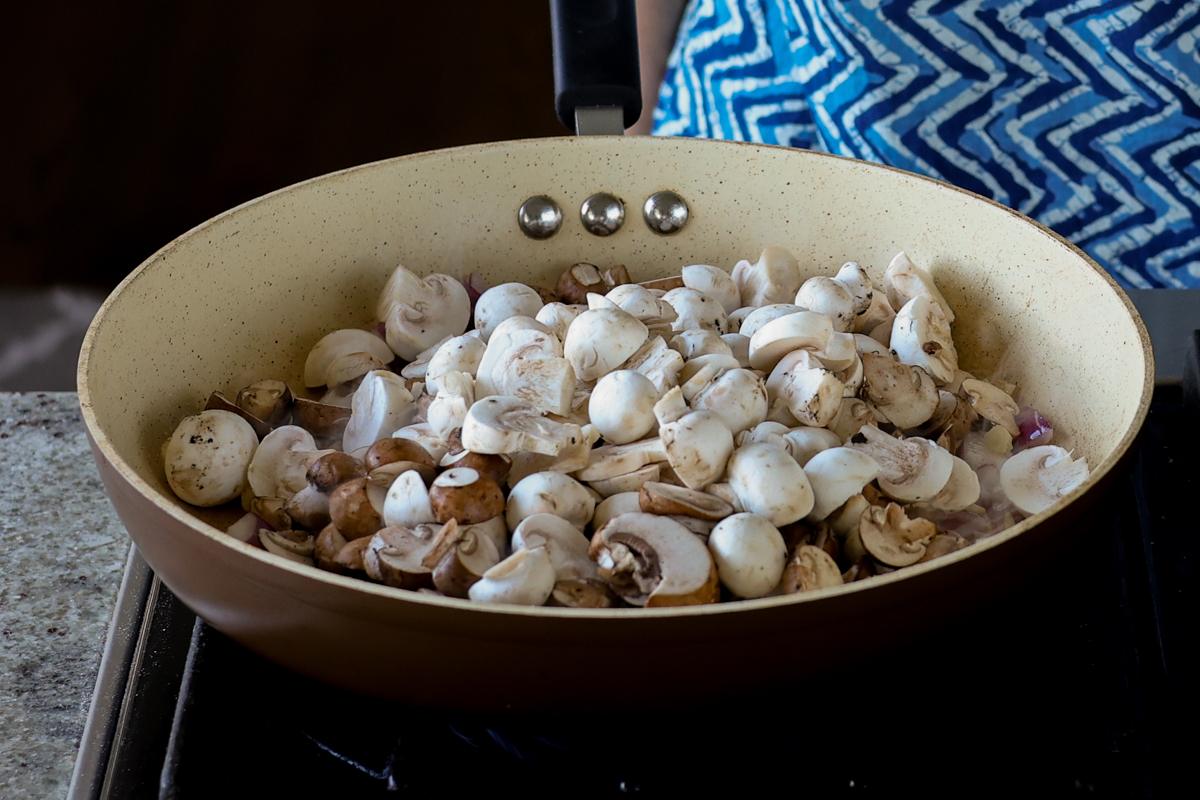adding mushrooms to the pan