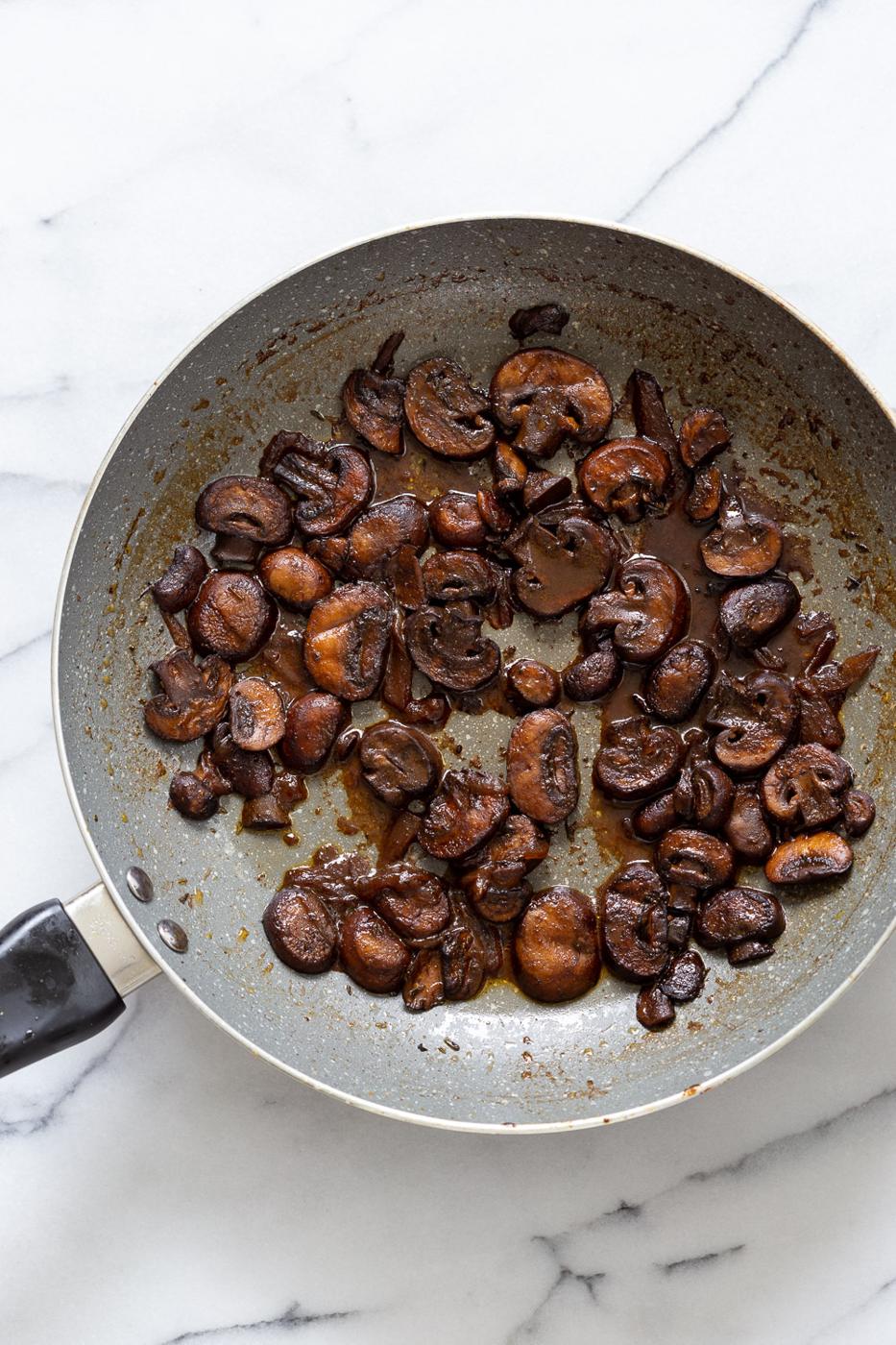 overhead shot of a pan with sauteed balsamic mushrooms