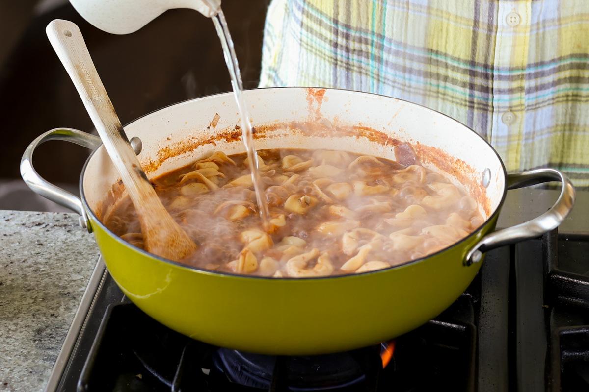 adding a splash of water to the pan