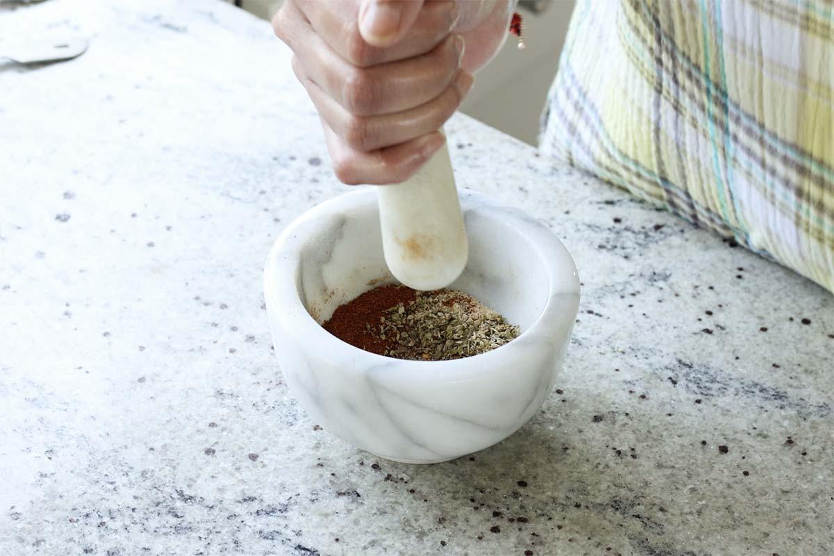 sausage spice mix in the mortar and pestle before grinding
