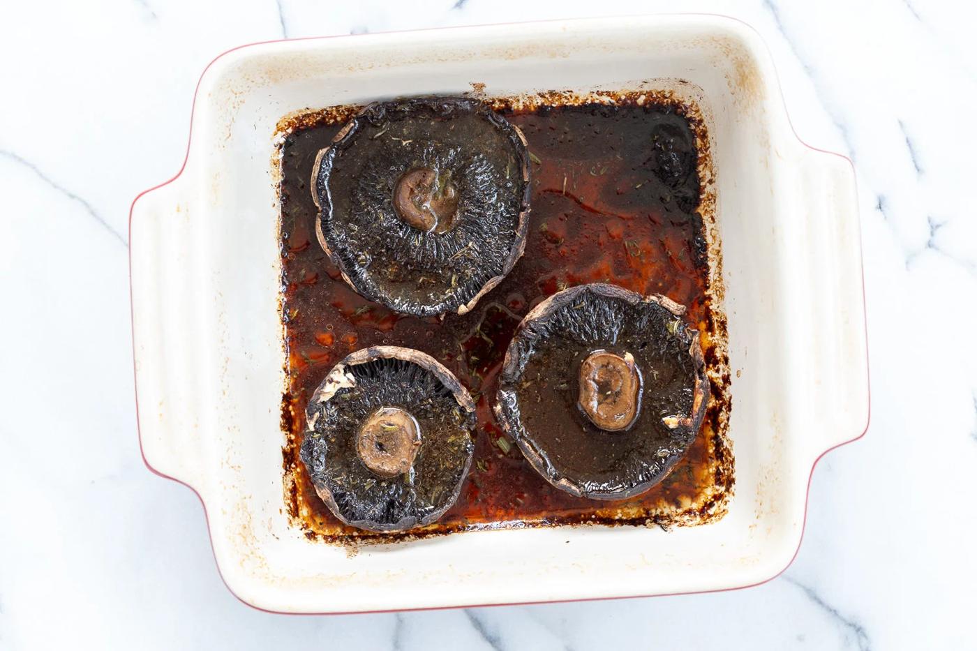 Marinated and Baked Portobello Mushrooms in a stoneware dish for Our Creamy Vegan Mushroom Lasagna
