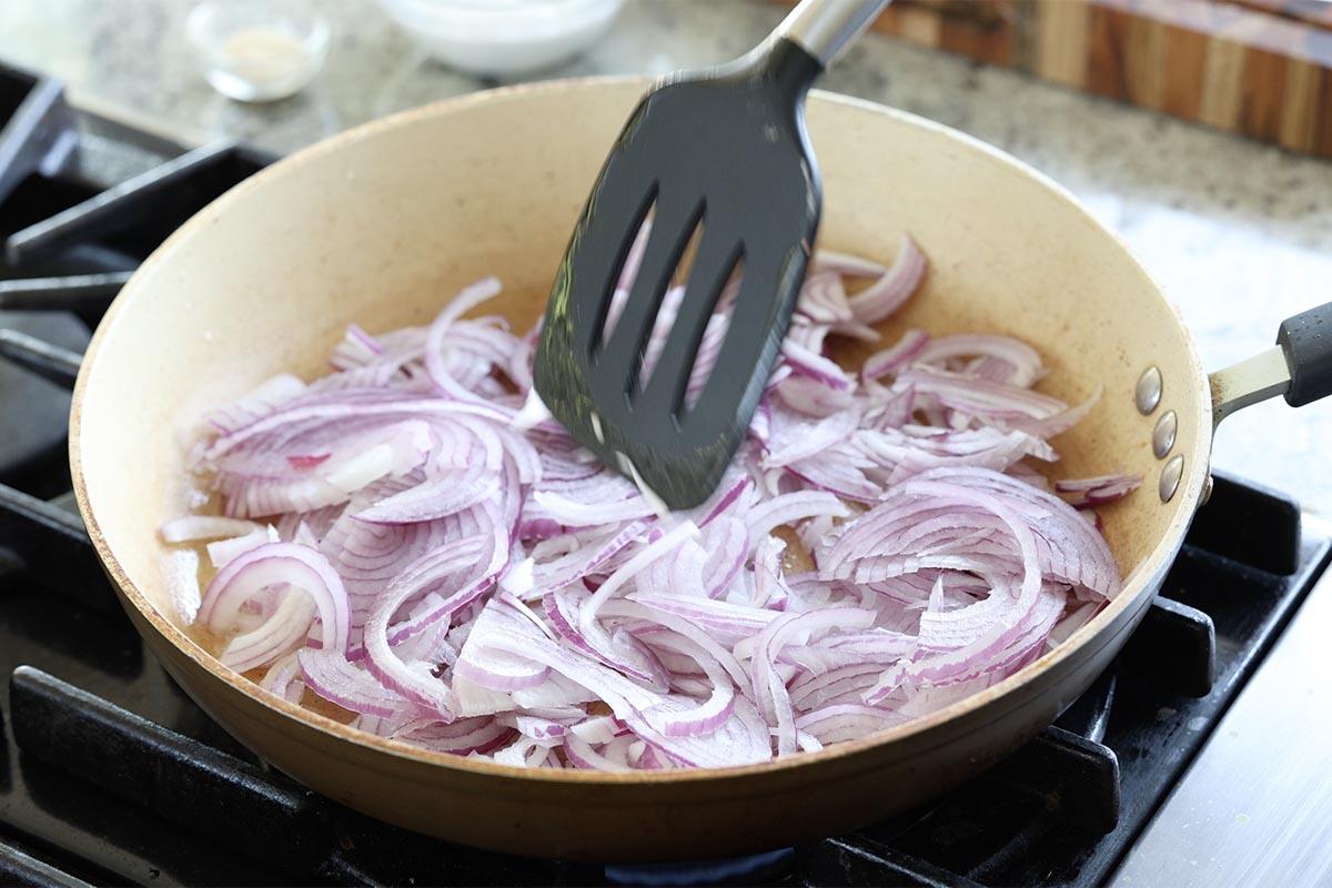 adding onions to the pan
