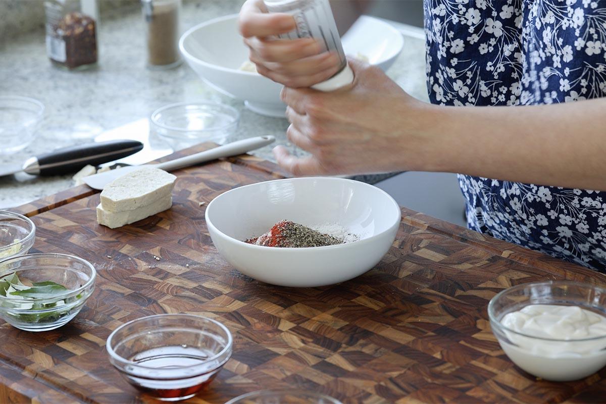 adding the spice mixture to a bowl