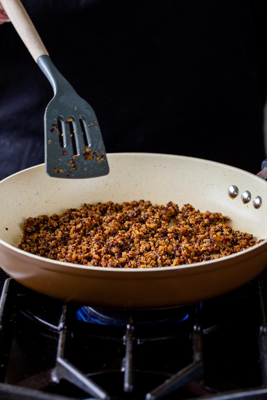 crisping up the quinoa taco meat in a frying pan