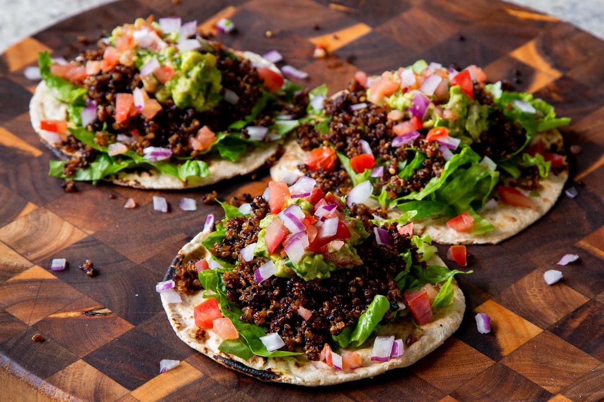 topping the quinoa tacos with pico de gallo