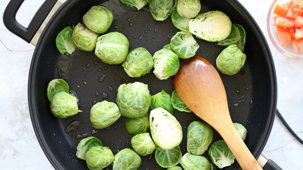 Brussels Sprouts getting pan roasted in a Black Skillet
