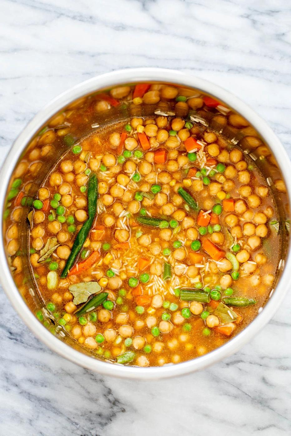 broth being added to dry ingredients to make chickpea fried rice