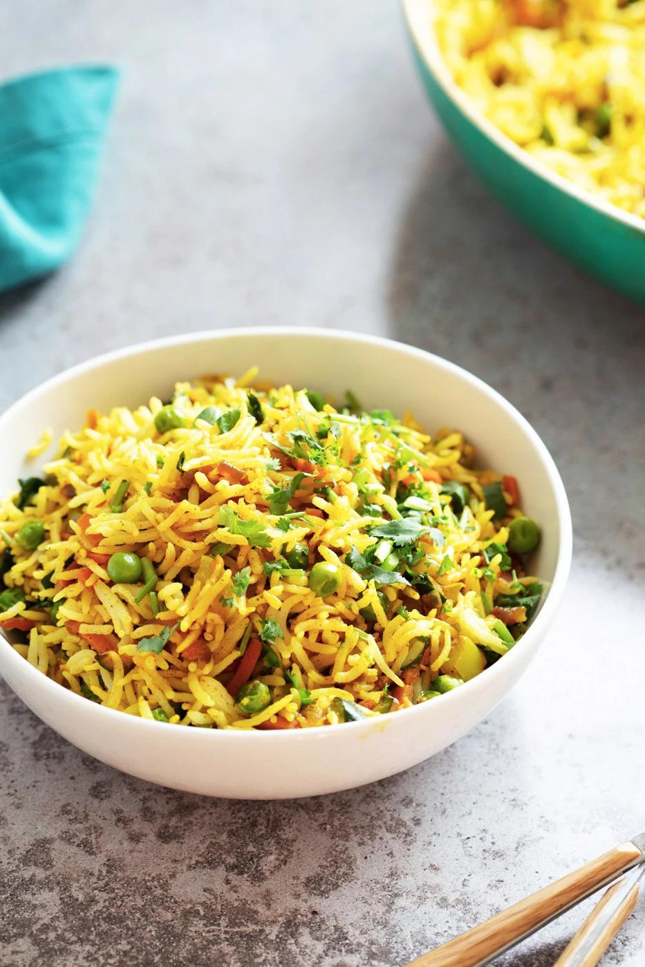 Curry fried rice in a white bowl on a work surface
