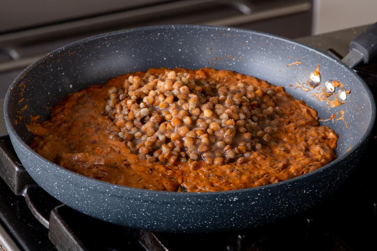 adding the lentils to the pan