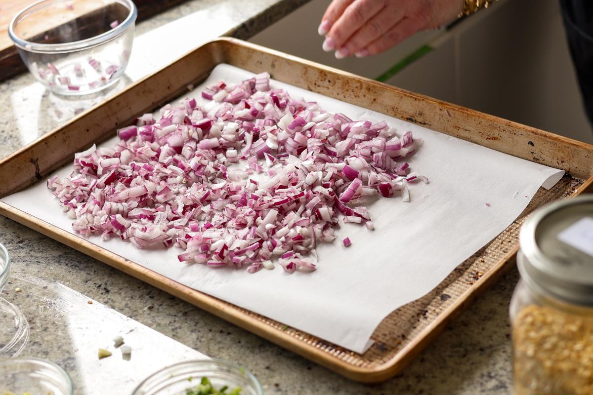 spreading onion onto the baking sheet