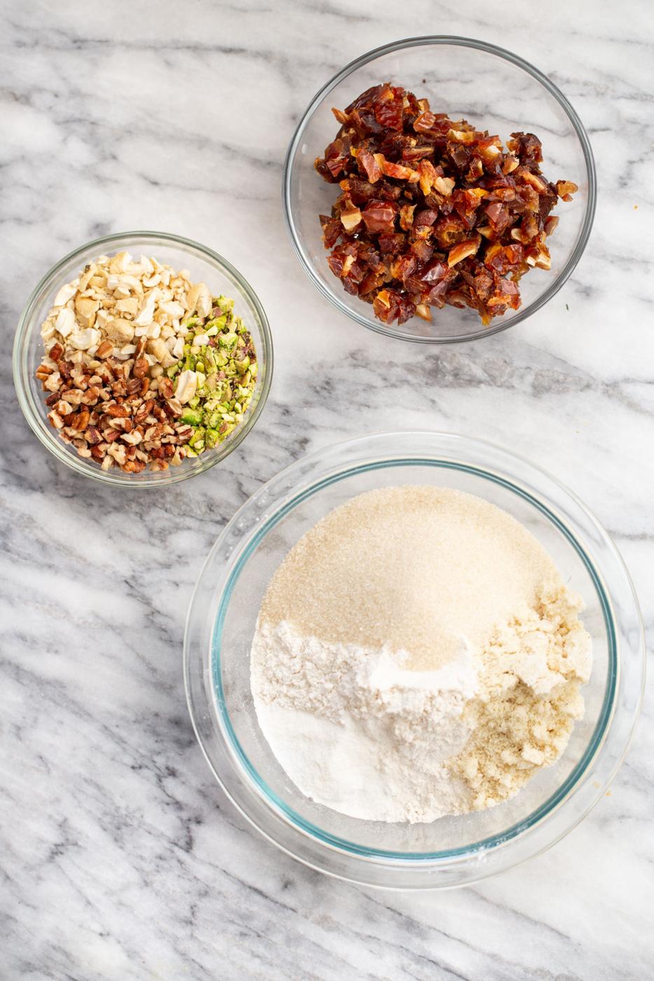 ingredients needed for making cookie mix in a jar on a marble countertop