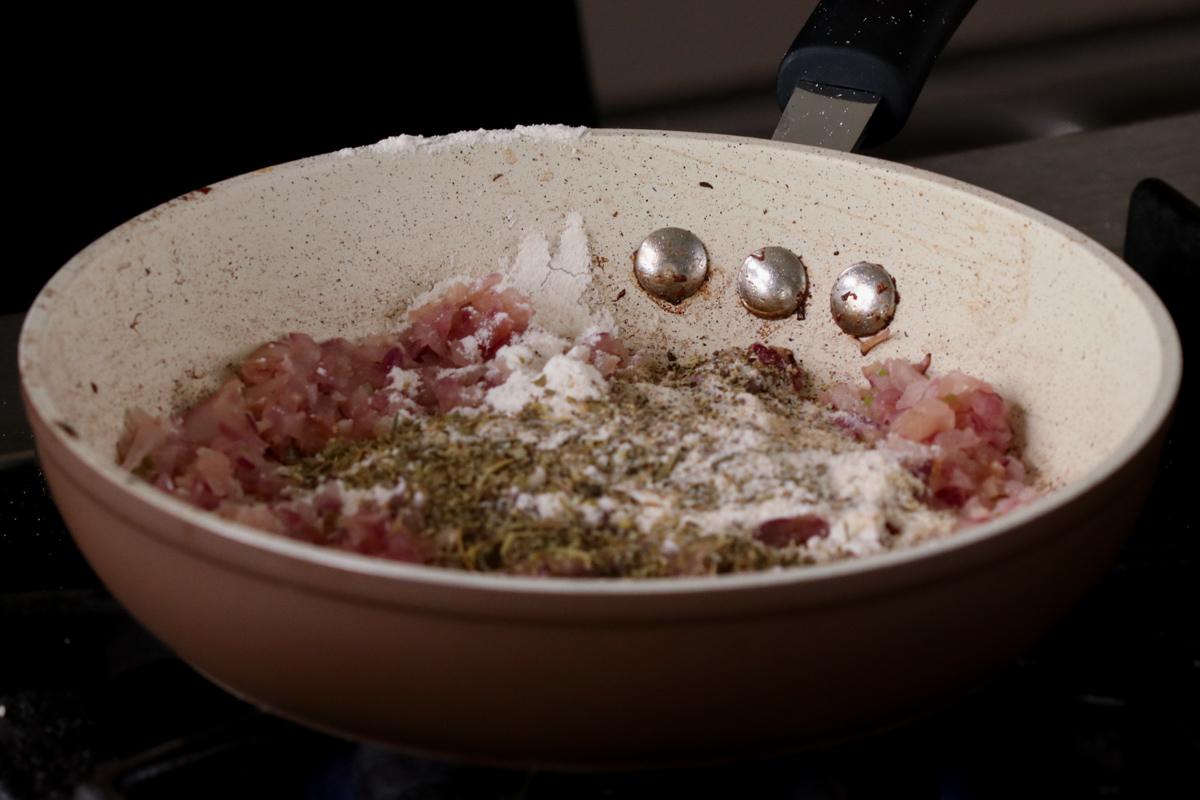 adding sauce ingredients to the onion and garlic in the pan