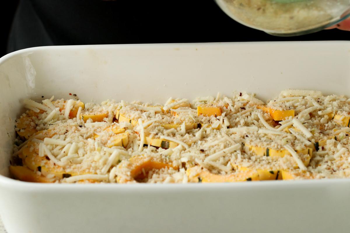 cheese-breadcrumb mixture added to the squash casserole in the pan, before baking
