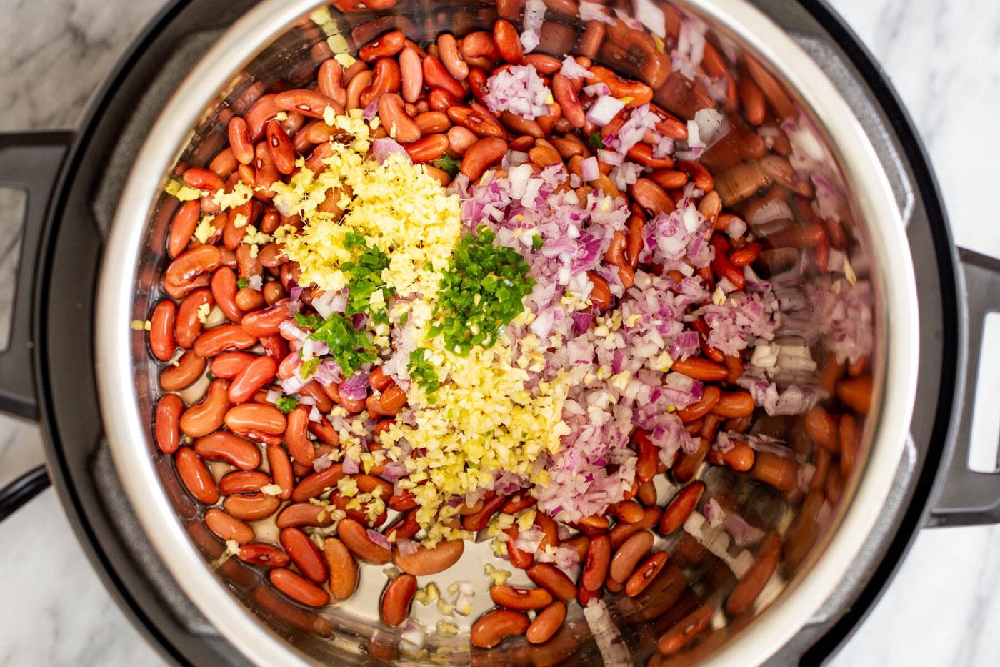 soaked red kidney beans with ginger, red onion and chili in an Instant Pot