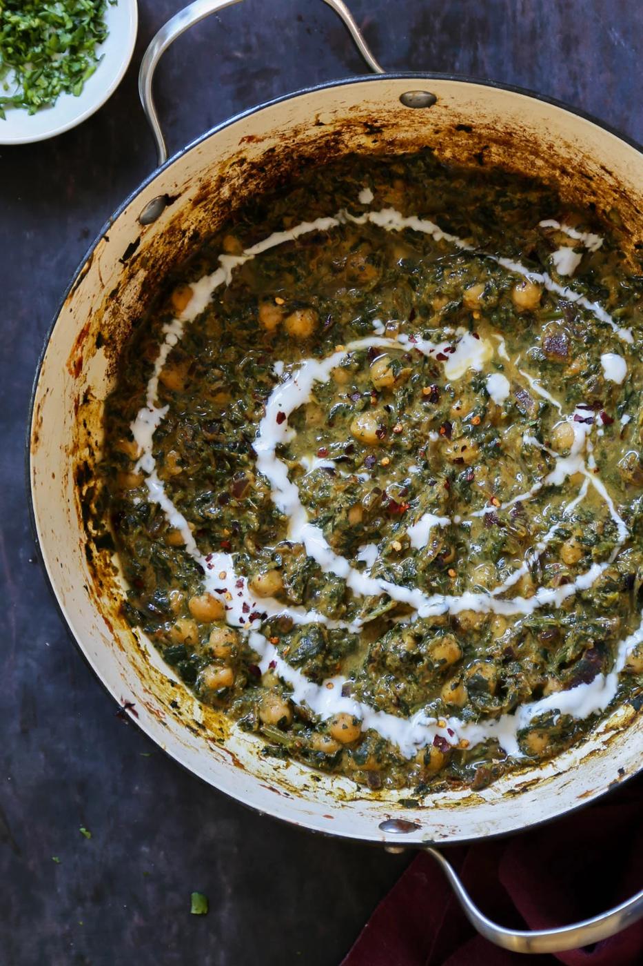 panful of chana saag after cooking with vegan cream and cilantro on top