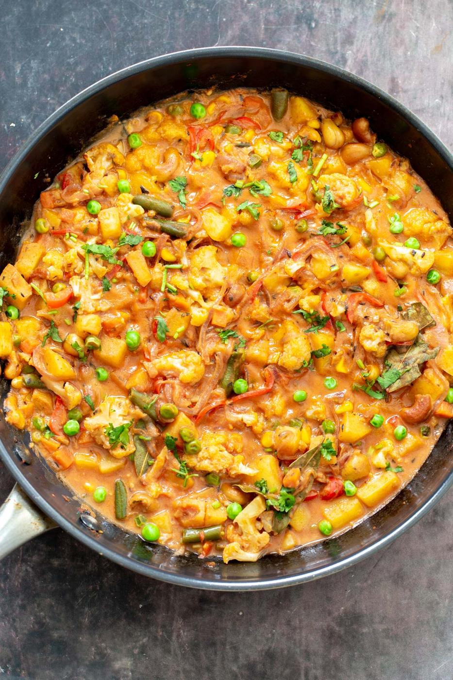 a sauteeing pan with vegetables mixed with creamy gravy